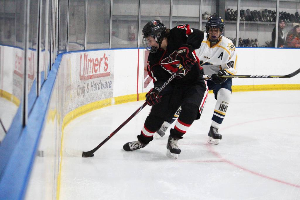 Kenais ????? grabs the puck out of the corner with Homers Isaiah Nevak on his heels during a game Friday, Nov. 16, 2018 during the End of the Road Shootout at Kevin Bell Arena in Homer, Alaska. (Photo by Megan Pacer/Homer News)