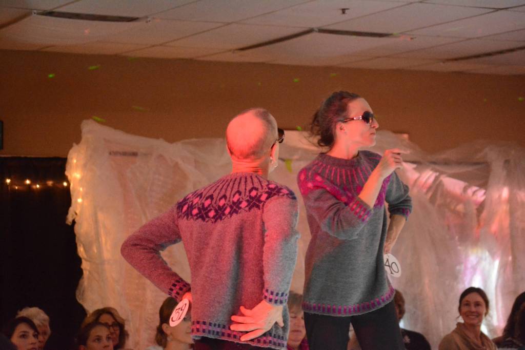 Craig Phillips, left, and Adele Person model Modern Icelandic Yoke Sweathers #1 and #2 by Ginger VanWagoner at the 2018 Wearable Arts on Nov. 17, 2018, in Homer, Alaska. (Photo by Michael Armstrong/Homer News)