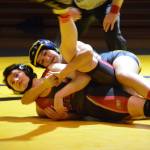 Homer High School Mariner Mina Cavasos, top, wrestles with Kenai High School Kardinal Olivia Easley,bottom, in an exhibition meet held Wednesday, Nov. 21, 2018, at the Homer High School Alice Witte Gym in Homer, Alaska. (Photo by Michael Armstrong/Homer News)