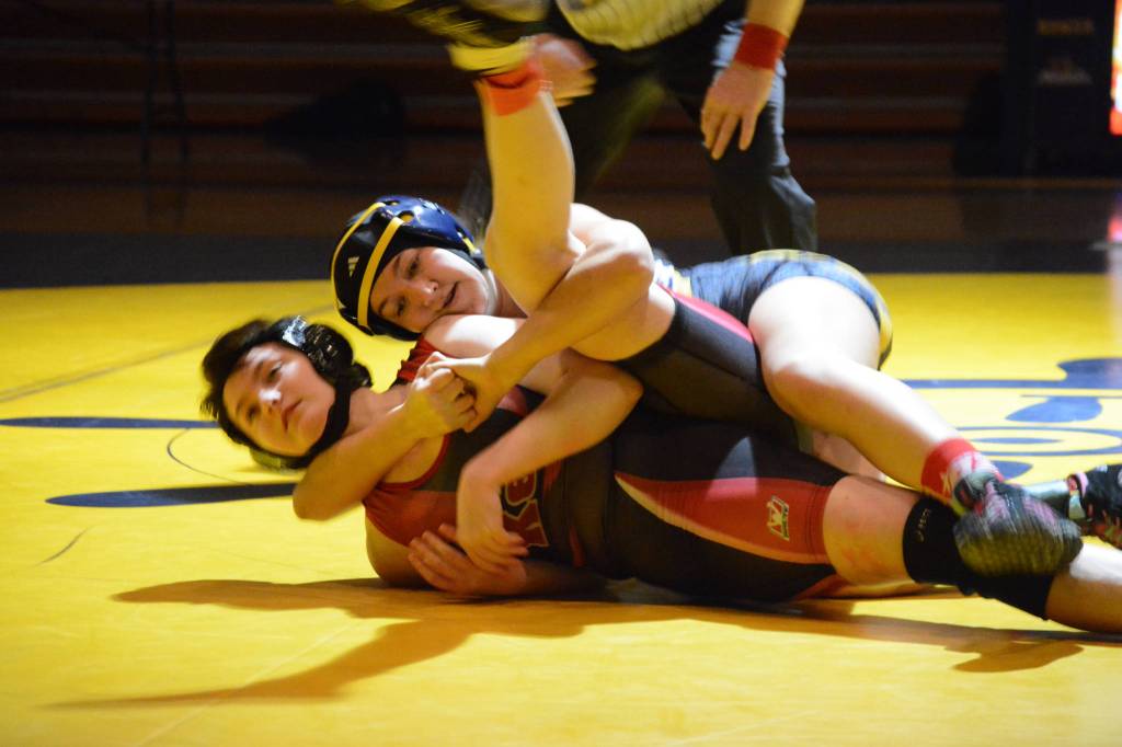 Homer High School Mariner Mina Cavasos, top, wrestles with Kenai High School Kardinal Olivia Easley,bottom, in an exhibition meet held Wednesday, Nov. 21, 2018, at the Homer High School Alice Witte Gym in Homer, Alaska. (Photo by Michael Armstrong/Homer News)