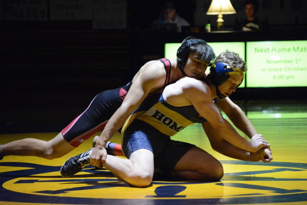 Homer High School Mariner Mose Hayes, right, wrestles with Kenai High School Kardinal Brandon Koto, left, in a meet held Wednesday, Nov. 21, 2018, at the Homer High School Alice Witte Gym in Homer, Alaska. (Photo by Michael Armstrong/Homer News)                                Homer High School Mariner Mose Hayes, right, wrestles with Kenai High School Kardinal Brandon Koto, left, in a meet held Wednesday, Nov. 21, 2018, at the Homer High School Alice Witte Gym in Homer, Alaska. (Photo by Michael Armstrong/Homer News)