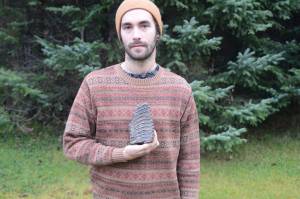 In a photo taken on Nov. 16, 2018, Aaron Carpenter holds a mammoth tooth he found on the beach north of Diamond Creek on Oct. 27, 2018, near Homer, Alaska. (Photo by Michael Armstrong/Homer News)