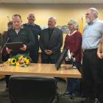 From left to right: Homer City Council members Rachel Lord, Caroline Venuti, Heath Smith, former Mayor Bryan Zak, council members Tom Stroozas and Shelly Erickson, Homer Mayor Ken Castner and City Manager Katie Koester celebrate an official recognition of Zak and his time serving the city during the councils Monday, Nov. 26, 2018 meeting at Homer City Hall in Homer, Alaska. (Photo by Megan Pacer/Homer News)