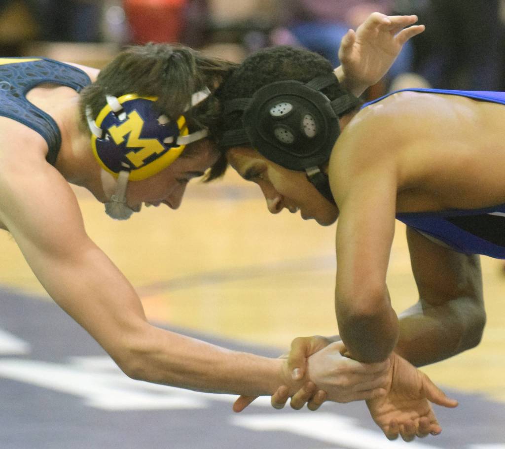 Homers Seth Inama and Soldotnas Ben Booth tangle at 125 pounds Tuesday, Nov. 27, 2018, at Soldotna Prep in Soldotna, Alaska. Inama would score a major decision. (Photo by Jeff Helminiak/Peninsula Clarion)