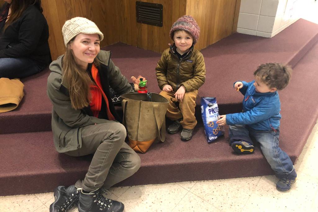 Katie Bower sits with her two children, Frederick and Lawrence, at the Homer High School, which was opened as a shelter after a 7 magnitude earthquake Friday, Nov. 30, 2018 in Homer, Alaska. A tsunami warning was issued for the Southern Kenai Peninsula but was lifted shortly after. (Photo by Renee Gross, KBBI)