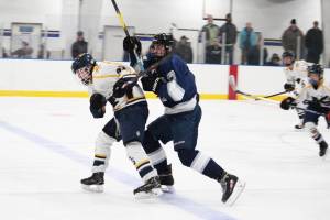 Homers Lee Lowe skates in front of Talyn Meyer to foil a breakaway the Eagle River skater got during their game Thursday, Nov. 29, 2018 at the Kevin Bell Ice Arena in Homer, Alaska. The Wolves beat the Mariners 8-0. (Photo by Megan Pacer/Homer News)