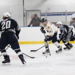 Homers Tyler Gilliland controls the puck while four Soldotna High School skaters close in on him during a Friday, Dec. 7, 2018 game at the Kevin Bell Ice Arena in Homer, Alaska. The game, which the Stars won 4-0, was a fundraiser to raise money for the Big Lake Rec Center in the Mat-Su Valley, which was damaged by the Nov. 30 earthquake. (Photo by Megan Pacer/Homer News)