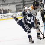 Homers Alden Ross battles for the puck with Soldotna High Schools Journey Miller during a Friday, Dec. 7, 2018 game at the Kevin Bell Ice Arena in Homer, Alaska. The game, which the Stars won 4-0, was a fundraiser to raise money for the Big Lake Rec Center in the Mat-Su Valley, which was damaged by the Nov. 30 earthquake. (Photo by Megan Pacer/Homer News)