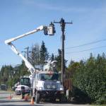 Homer Electric Association crews work on a powerline on Lake Street in Homer, Alaska, on Aug. 17, 2018. (Photo by Michael Armstrong/Homer News)