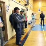 Members of the HERC Task Force and the public, located in the gym currently used for community recreation, listen to city staff talk about the state of the building during a walk-through Tuesday, June 26, 2018 in Homer, Alaska. (Photo by Megan Pacer/Homer News)