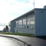 The HERC Building as seen in a 2010 file photo from the upper parking lot at Woodside Avenue. At the time the Kachemak Bay Campus used the building as temporary office and classroom space while the Pioneer Avenue building was being remodeled, one of several uses of the HERC since the city acquired it from the Kenai Peninsula Borough in 2000. (Homer News file photo)