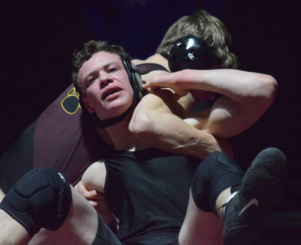 Nikiskis Koleman McCaughey fights against Graces Gabe Martin on Saturday, Dec. 8, 2018 in the 160-pound championship at the Kachemak Conference wrestling tournament at Grace Christian High School in Anchorage, Alaska. (Photo by Joey Klecka/Peninsula Clarion)