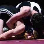 Nikiskis Jaryn Zoda battles against Caleb OHara of ACS on Saturday, Dec. 8, 2018 in the 112-pound championship at the Kachemak Conference wrestling tournament at Grace Christian High School in Anchorage, Alaska. (Photo by Joey Klecka/Peninsula Clarion)