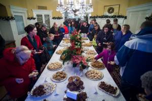 Juneau residents file through the dining room for cookies at the Governors Open House on Tuesday, Dec. 11, 2018. (Michael Penn | Juneau Empire)