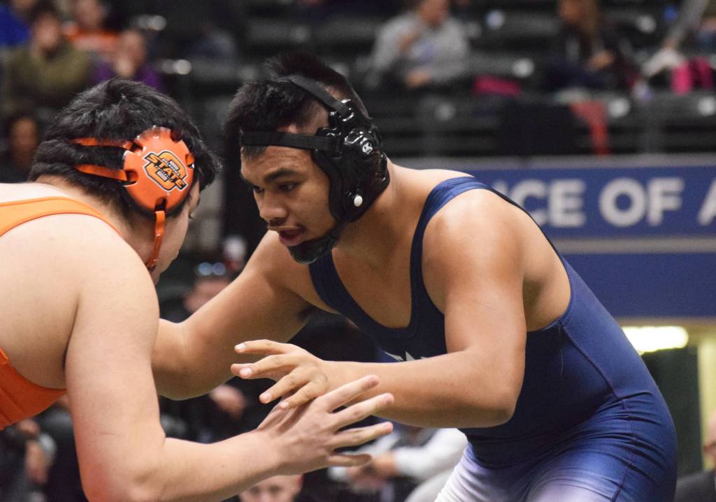 Soldotna senior Aaron Faletoi anticipates the moves of West Anchorages Kelton Mock in the 215-pound final Saturday, Dec. 15, 2018 at the Div. I state wrestling championships at the Alaska Airlines Center in Anchorage, Alaska. (Photo by Joey Klecka/Peninsula Clarion)