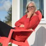 Kim Steutermann Rogers of Kauai, Hawaii, sits on the deck of Frederica, a small cabin on the Storyknife writers retreat property, on Sept. 27, 2016, near Homer, Alaska. She was the first Storyknife resident. (Photo by Michael Armstrong/Homer News)