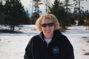 Dana Stabenow stands in April 2013 on the future site of Storyknife, the writers retreat she and her foundation plan to build near Homer, Alaska. The retreat is on the Homer bluff with a view of lower Cook Inlet, including Iliamna and Redoubt Volcanoes. (Photo by Michael Armstrong/Homer News)