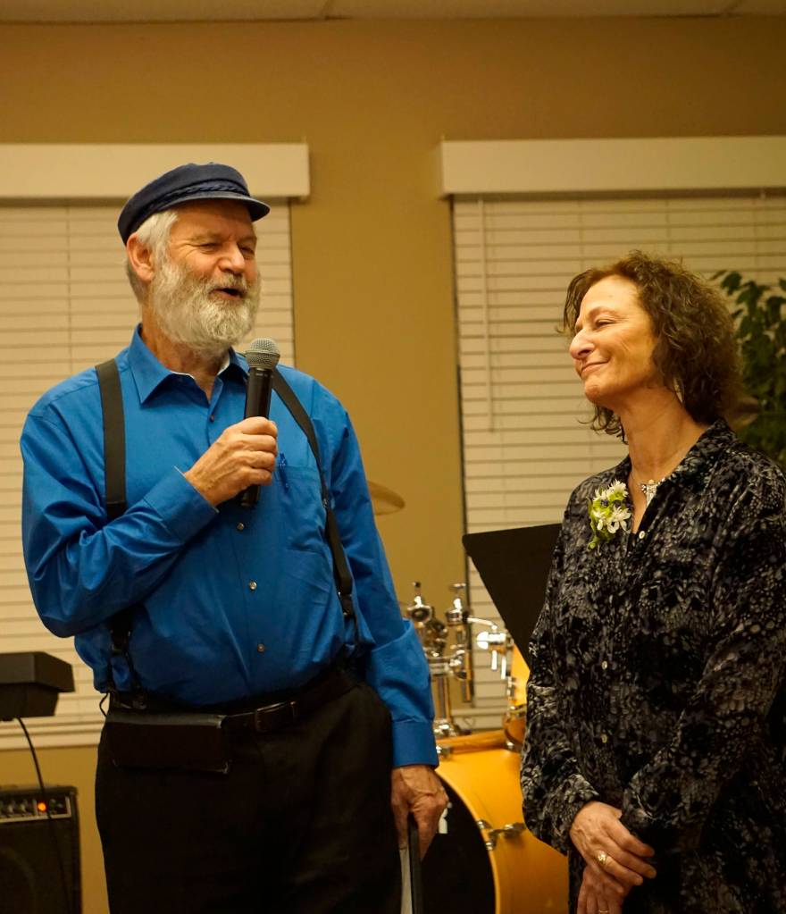 Kachemak Bay Campus Director Carol Swartz, right, smiles as Rep. Paul Seaton, NP-Homer, left, presents her with a Legislative Proclamation at her retirement party Lands End Resort on Friday, Dec. 14, 2018 in Homer, Alaska. Swartz ends her job as director at the end of the year. Friends joined her in celebrating her tenure as director of the local branch campus of Kenai Peninsula College, University of Alaska Anchorage. (Photo by Michael Armstrong/Homer News)