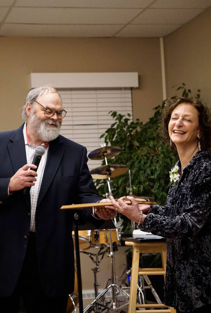 Kachemak Bay Campus Director Carol Swartz, right, laughs as Homer Mayor Ken Castner, left, presents her with a Mayoral Recognition  but not a proclamation  at her retirement party Lands End Resort on, Dec. 14, 2018 in Homer, Alaska. Swartz ends her job as director at the end of the year. Friends joined her in celebrating her tenure as director of the local branch campus of Kenai Peninsula College, University of Alaska Anchorage. (Photo by Michael Armstrong/Homer News)