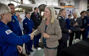 In this file photo, Rep. Cathy Munoz, R-Juneau, greets Airlift Northwest pilots Randy Aspeluind, left, and Tyler Cousins during a bill signing by Gov. Sean Parnell at the air ambulance companys hangar at the Juneau International Airport on Wednesday, April 23, 2014. (Michael Penn | Juneau Empire File)