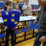 Chapman 4th-grade student Miles Tressler displays a Flag of Peace he painted on Dec. 6, 2018 at Chapman School in Anchor Point, Alaska. (Photo provided)