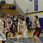 Mariner Seth Adkins looks for an opening during a basketball game between the Homer Mariners and the Kenai Kardinals on Friday, Dec. 21, 2018, at the Homer High School Alice Witte Gym in Homer, Alaska. (Photo by Michael Armstrong/Homer News)