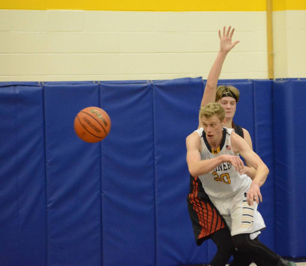 Mariner Japheth McGhee passes the ball during a basketball game between the Homer Mariners and the Kenai Kardinals on Friday, Dec. 21, 2018, at the Homer High School Alice Witte Gym in Homer, Alaska. (Photo by Michael Armstrong/Homer News)