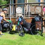 Sohpie George and Chris Haag put the finishing touches on their bikes before setting off on a two-year trek from Alaska to Argentina on Saturday, June 30, 2018 on Hidden Way in Homer, Alaska. The husband and wife packed up their life in Utah prior to the adventure. (Homer News file photo)