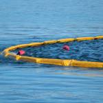 The apex of a boom holds two buoys placed in the water to simulate areas of oil slick fishing vessels needed to aim for during annual oil spill response training held Saturday, April 14, 2018 in Homer, Alaska. (Homer News file photo)