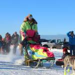 Monica Zappa, in her telltale neon garb, takes off with her team from the starting line of this years Tustumena 200 Sled Dog Race on Saturday, Jan. 27, 2018 at Freddies Roadhouse in Ninilchik, Alaska. (Homer News file photo)