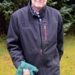 In this photo taken on Nov. 26, 2018, Don Henry holds an astagalus, or ankle bone, he found on the Mud Bay side of the Homer Spit earlier this month. (Homer News file photo)