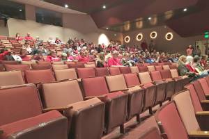 Teachers, support staff and community members, many of them wearing red, prepare to listen to the Kenai Peninsula Borough School District Board of Educations Monday, Sept. 10, 2018 meeting at Homer High School in Homer, Alaska. The board holds one meeting each year in Homer, and another in Seward. (Photo by Megan Pacer/Homer News)