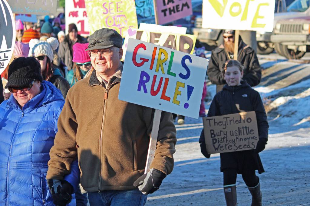 A man walks in the 2019 Womens March on Homer while carrying a sign that reads Girls Rule! on Saturday, Jan. 19, 2019 in Homer, Alaska. (Photo by Megan Pacer/Homer News)