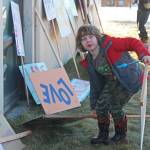 Evan Spencer, 6, of Anchor Point, opts for a different sign to carry Saturday, Jan. 19, 2019 at the third Womens March on Homer at the Homer Education and Recreation Complex in Homer, Alaska. (Photo by Megan Pacer/Homer News)
