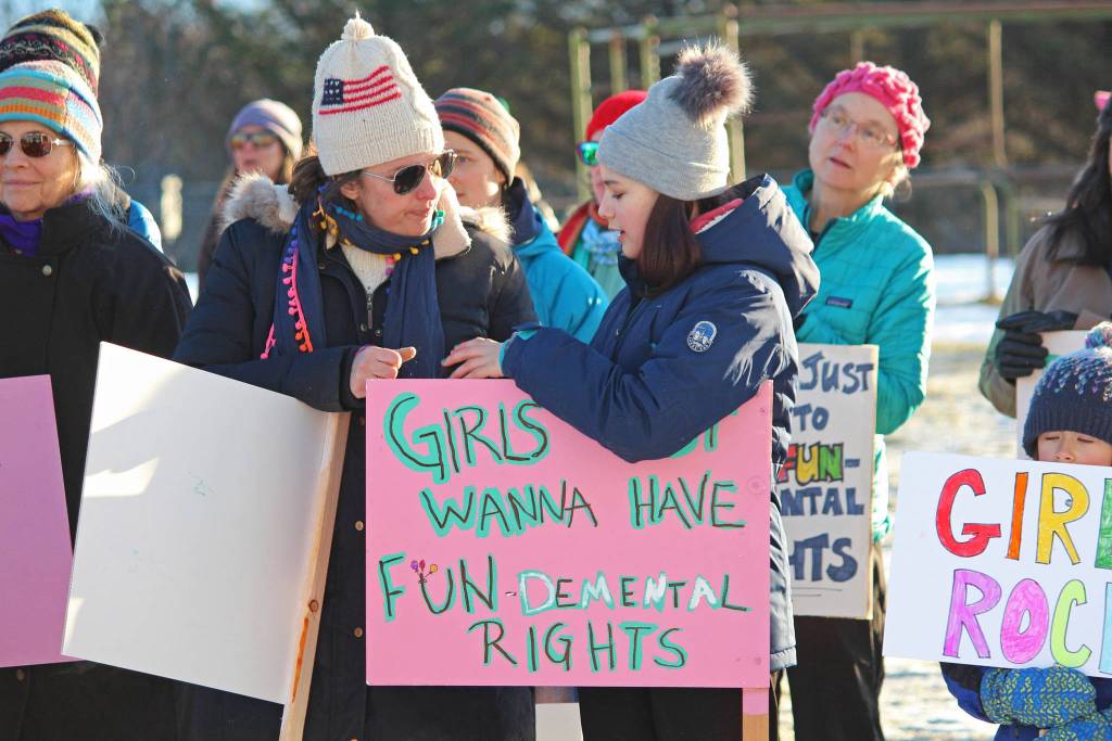 A girl stands ready for the 2019 Womens March on Homer with a sign that reads, Girls just wanna have fundamental rights, on Saturday, Jan. 19, 2019 at the Homer Education and Recreation Complex in Homer, Alaska. (Photo by Megan Pacer/Homer News)