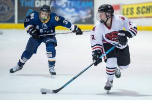 Juneau-Douglas Kyler Alderfer, right, moves the puck in front of Homers Casey Otis at Treadwell Arena on Friday, Jan. 18, 2019. JDHS won 4-3 in overtime. (Michael Penn/Juneau Empire)