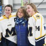 Homer seniors Ali McCarron (left) and Brenna McCarron (Right) are honored with they mom, Julie, on Senior Night for the Homer High School hockey team Thursday, Jan. 24, 2019 at Kevin Bell Arena in Homer, Alaska. The Mariners defeated Houston High School 10-1. (Photo by Megan Pacer/Homer News)