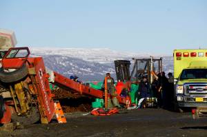 Homer Volunteer Fire Department emergency medical technicians treat a person injured when a crane tipped over at the Pioneer Dock on the Homer Spit at about 1:55 p.m. Jan. 31, 2019, in Homer, Alaska. (Photo by Michael Armstrong/Homer News.)