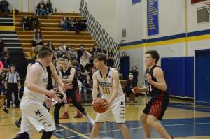 Mariner Seth Adkins looks for an opening during a basketball game between the Homer Mariners and the Kenai Kardinals on Friday, Dec. 21, 2018, at the Homer High School Alice Witte Gym in Homer, Alaska. (Photo by Michael Armstrong/Homer News)