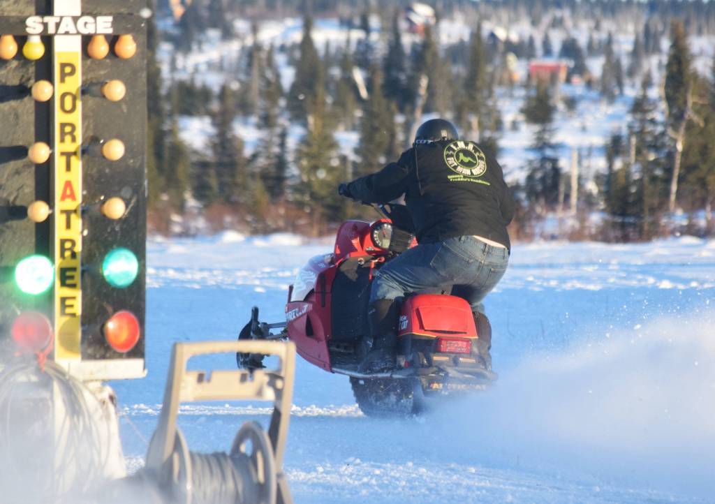 Freddie Pollard Jr. takes off during a heat race Saturday afternoon at the snowmachine drag races at Freddies Roadhouse near Ninilchik. (Photo by Joey Klecka/Peninsula Clarion)
