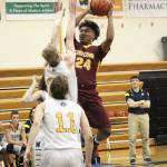Mt. Edgecumbes Emmett Dunaway attempts a shot under pressure from several Mariners during a Thursday, Jan. 10, 2019 game in Homer, Alaska. (Photo by Megan Pacer/Homer News)