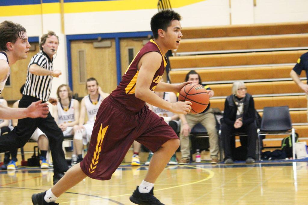 Mt. Edgecumbes RJ Alstrom-Beans moves down the court under the pursuit of Homers Seth Adkins during a Thursday, Jan. 10, 2019 game in Homer, Alaska. (Photo by Megan Pacer/Homer News)