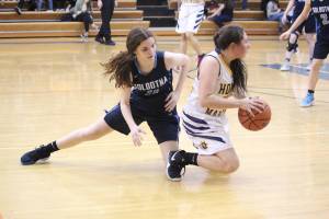 Homers Hannah Hatfield wins a loose ball from Soldotna High Schools Morgan Bouschor during a Tuesday, Jan. 15, 2019 game in Homer, Alaska. (Photo by Megan Pacer/Homer News)