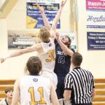 Homers Japheth McGee and Soldotnas David Michael jump for the tipp off at the start of a Tuesday, Jan. 15, 2019 basketball game between the two schools in Homer, Alaska. (Photo by Megan Pacer/Homer News)