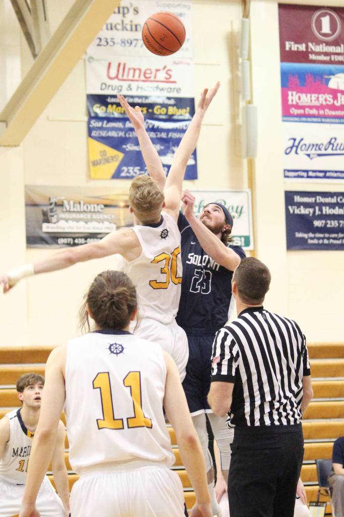 Homers Japheth McGee and Soldotnas David Michael jump for the tipp off at the start of a Tuesday, Jan. 15, 2019 basketball game between the two schools in Homer, Alaska. (Photo by Megan Pacer/Homer News)