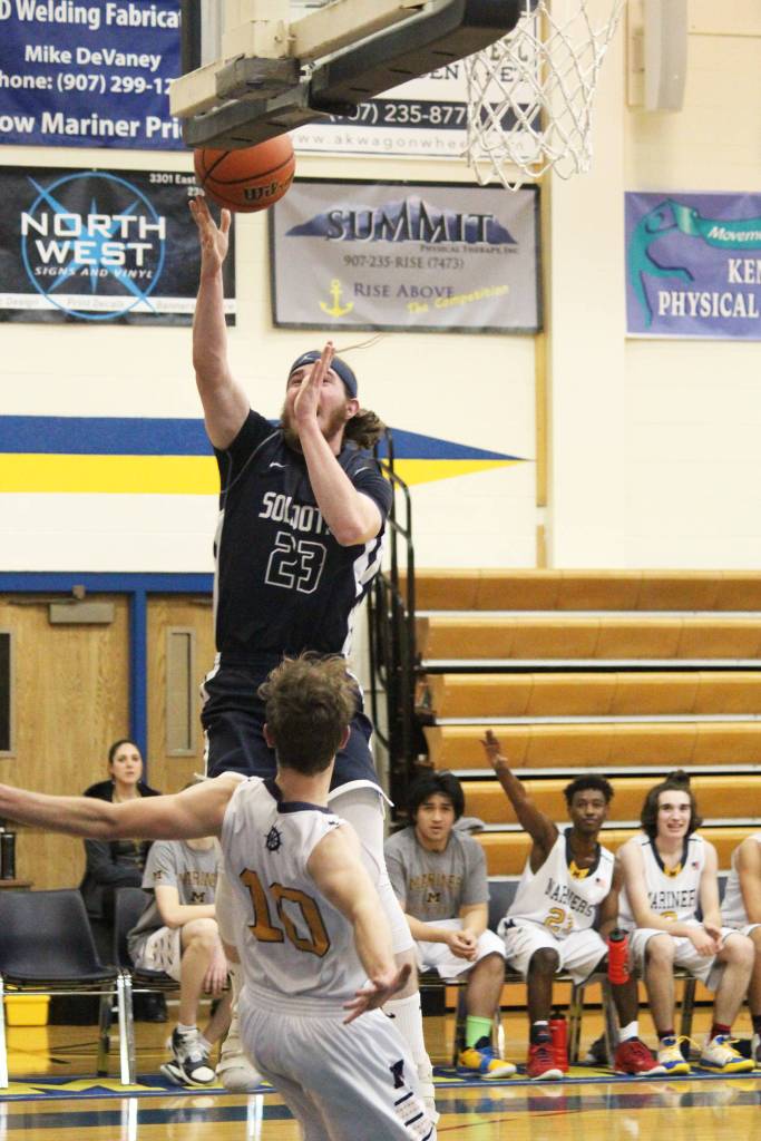 Soldotna High Schools David Michael bolls over Homers Seth Adkins while taking a shot during a Tuesday, Jan. 15, 2019 game in Homer, Alaska. (Photo by Megan Pacer/Homer News)