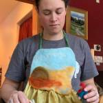 Hanna Young shows her story apron, a surface for telling stories using her felted characters. (Photo provided)