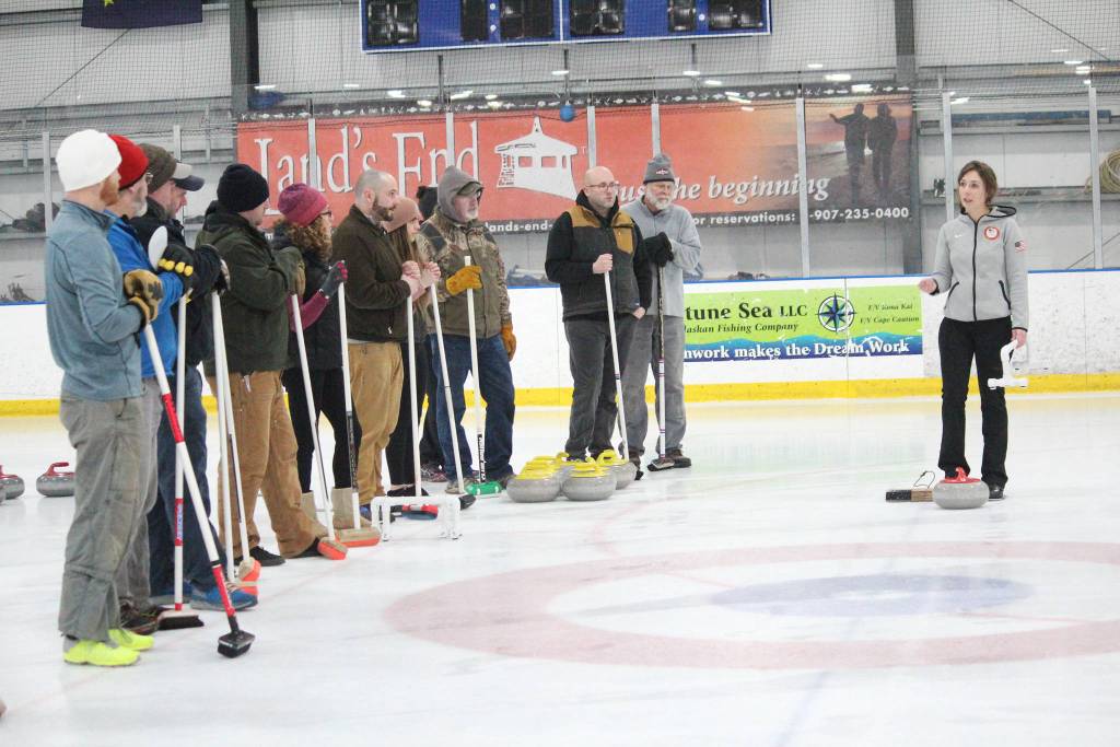 Former Olympic curler Jessica Schultz explains the basics of the sport to a group of people Saturday, Jan. 12, 2019 at the Kevin Bell Ice Arena in Homer, Alaska during a fundraiser event for the Homer Curling Club. (Photo by Megan Pacer/Homer News)