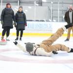 Natalie Jones turns back to laugh with her friends after toppling over while sliding a curling stone Saturday, Jan. 12, 2019 at a Learn to Curl fundraising event at the Kevin Bell Ice Arena in Homer, Alaska. (Photo by Megan Pacer/Homer News)