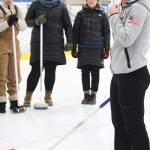 Former Olympic curler Jessica Schultz explains the basics of the sport to a group of people Saturday, Jan. 12, 2019 at the Kevin Bell Ice Arena in Homer, Alaska during a fundraiser event for the Homer Curling Club. (Photo by Megan Pacer/Homer News)